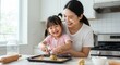 © sopix - Mother and daughter baking cookies together in kitchen sharing family time preparing dough balls with love and happiness domestic scene