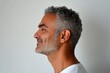 © R - Fashionable men's fade haircut - midlife arabian man with curly hair. Creative of style for aging men. Pure white solid background. A strong and handsome man standing with grace.