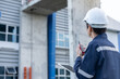 © Shisu_ka - maintenance and inspector. Maintenance engineers are using walky talky to inform the results of inspection of buildings and structures. Irrigation engineers are exploring sluice systems