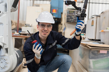 Fototapete - Robotic arm, Automatic robotic arm welding. Robotic manufacturing industry. Engineer setup, install, maintain, repair mechanism of operation of robotic arm in storage warehouse