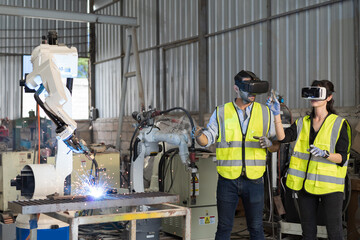 Fototapete - Robotic arm, Automatic robotic arm welding. Team of engineers install, maintain, repair mechanism of operation of robotic arm welding in robotic storage warehouse