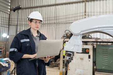 Aufkleber - Robotic arm, Robotic manufacturing industry. Woman engineer working with laptop computer for setup, install, maintain, repair mechanism of operation of robotic arm in workshop