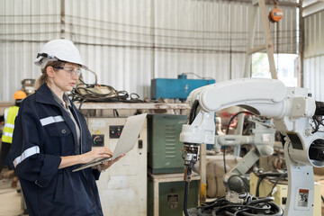 Aufkleber - Robotic arm, Robotic manufacturing industry. Woman engineer working with laptop computer for setup, install, maintain, repair mechanism of operation of robotic arm in workshop