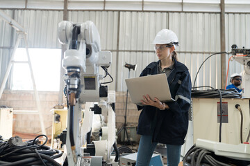 Aufkleber - Robotic arm, Robotic manufacturing industry. Woman engineer working with laptop computer for setup, install, maintain, repair mechanism of operation of robotic arm in workshop