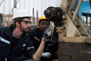 Leinwandbilder - Robotic arm, Automatic robotic arm welding. Robotic manufacturing industry. Team of engineers setup, install, maintain, repair mechanism of operation of robotic arm in storage warehouse