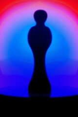 Wall Mural - Abstract silhouette of a chess pawn illuminated by vibrant colorful lighting