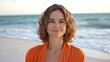 © Jolin - Woman on beach with orange towel, warm sunlight, serene ocean backdrop; embodying calm and natural beauty.