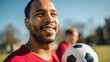 © Postmodern Studio - Joyful young man playing soccer outdoors on a bright sunny day
