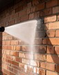 © Simon - Pressure washing red brick wall for clean and restored appearance