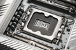 © Владимир Трубачёв - High-resolution macro image showing a close-up view of an empty CPU socket on a modern computer motherboard. Detailed view of metal contacts and electronic components.