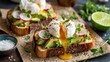 © Daryna - Avocado toast homemade with poached egg showing flowing golden yolk over creamy smashed surface alongside second toast with radishes and microgreens