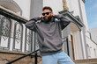 © San4ezz007 - Bearded hipster in dark grey hoodie and sunglasses – urban apparel mockup