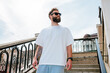 © San4ezz007 - White T-shirt on a bearded hipster in sunglasses — urban mockup for brands