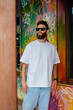 © San4ezz007 - White T-shirt on a bearded hipster in sunglasses — urban mockup for brands