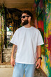 © San4ezz007 - White T-shirt on a bearded hipster in sunglasses — urban mockup for brands