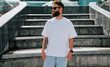 © San4ezz007 - White T-shirt on a bearded hipster in sunglasses — urban mockup for brands