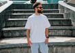 © San4ezz007 - White T-shirt on a bearded hipster in sunglasses — urban mockup for brands