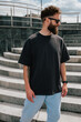 © San4ezz007 - Bearded hipster in black t-shirt and sunglasses — urban mockup for brands