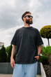 © San4ezz007 - Bearded hipster in black t-shirt and sunglasses — urban mockup for brands