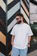 © San4ezz007 - White T-shirt on a bearded hipster in sunglasses — urban mockup for brands