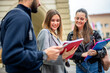 © Mediteraneo - Three students discuss lectures and literature while they are outside.