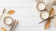 © Hryhor Denys - Cozy home decor items displayed on white wooden surface with autumn leaves and candles creating relaxing setting for lifestyle template