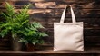 © Julia - A rustic wooden table serves as the backdrop for a cream-colored tote bag, flanked by lush green potted plants, catering to the needs of eco-friendly shoppers