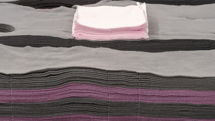 Aufkleber - A stack of pink napkins on a gray surface. The napkins are folded and stacked on top of each other