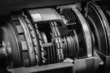Aufkleber - A dark black close up of a machine with many gears and discs. concept of powerful industrial energy of complexity and intricacy, and a sense of awe at engineering behind machine.