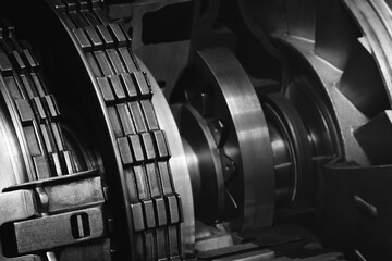 Aufkleber - A dark black close up of a machine with many gears and discs. concept of powerful industrial energy of complexity and intricacy, and a sense of awe at engineering behind machine.