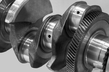 Aufkleber - Close-up of a car crankshaft with visible gears. The shaft is made of metal and has a shiny appearance, repair and service transport concept