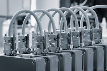 Poster - A row of computer cables are lined up in a row. The cables are white and grey