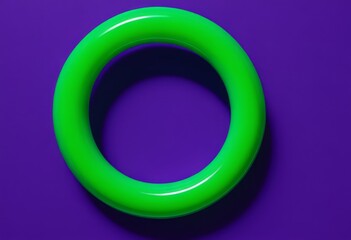 Wall Mural - Close-up of green ring on purple surface