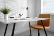 © Ghiska - Minimalist home office desk with lamp plant and contemporary chair