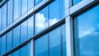 © Pastel - A modern building facade reflecting clouds and sky, showcasing sleek glass panels and a contemporary architectural design