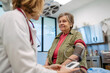 © Halfpoint - Senior woman having blood pressure checked, preventive care.