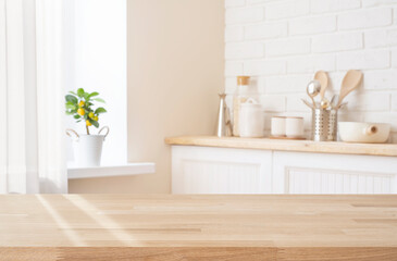 Wall Mural - empty wooden table top on blurred kitchen utensils interior background and curtained window sill wit