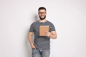 Handsome man using tablet on white background