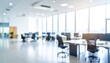 © SSuperTier - A softly blurred office interior with neutral tones and open-plan desks creates a clean, modern corporate atmosphere. Natural light streams through large windows, casting subtle highlights across the