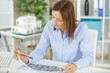 © auremar - woman architect working with plans