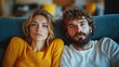 © paukan - Upset couple on sofa, living room, bored, watching TV, relationship problems
