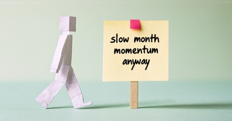 Fototapete - Paper figure pushing yellow note. Text reads slow month momentum anyway. Simple concept, light background.