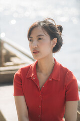 Poster - Young southeast asian woman entrepreneur and small business owner working remote as businesswoman outdoors with natural light and calm emotional expression