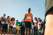 © Jacob Lund - Excited male runner celebrating with cheering crowd after a race
