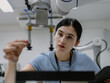 © Nassorn - Hispanic engineer woman working on AI technology in robotics electronics engineering laboratory. University students' research project is programming robot machine with intelligent mechanical control