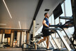 © Serhii - Determined man running on treadmill during rehabilitation in modern gym