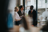Three people engage in a discussion in a stylish co working setting, fostering collaboration and productivity in a dynamic business environment.