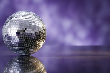 Wall Mural - disco ball on purple background creates a festive atmosphere for parties and celebrations with its s