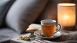 © Olga - Cozy bedroom scene with steaming tea and warm lighting