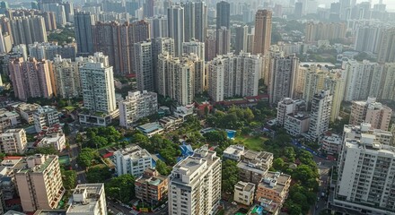  Dense urban sprawl reveals a sprawling city with diverse architecture under a hazy sky panorama.